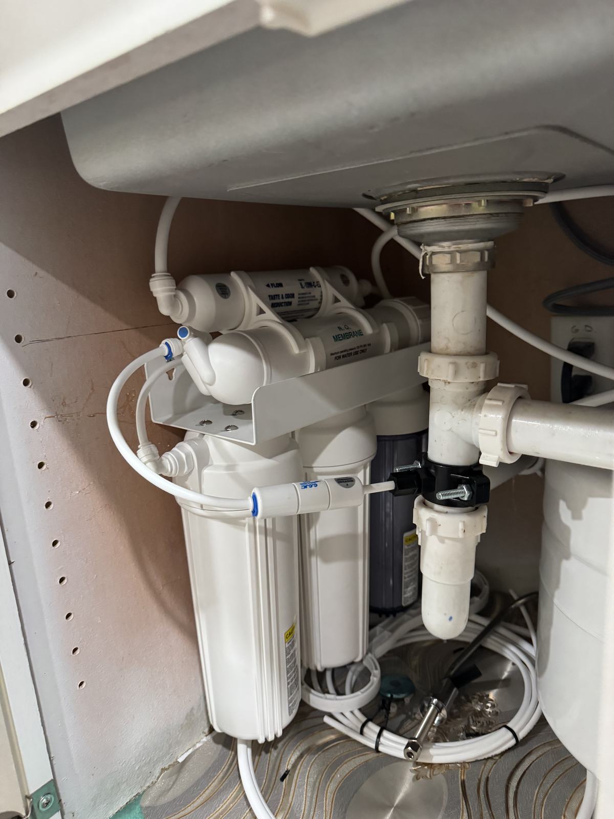 Under-sink reverse osmosis system professionally installed and secured